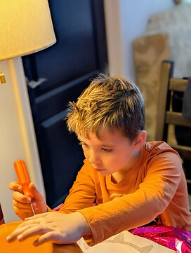 Grandson carving his pumpkin